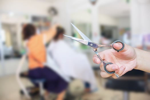 Hairdresser hold scissors with salon beauty background photo