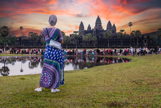 Tourist woman watching sunrise at Angkor Wat temple Siem Reap Cambodia. photo