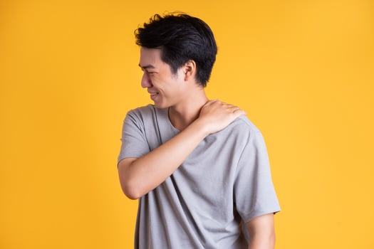 Asian young man posing on a yellow background photo