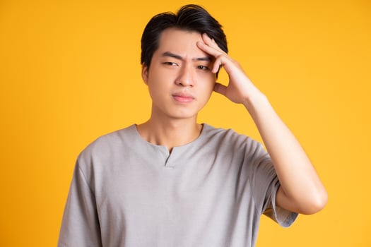 Asian young man posing on a yellow background photo
