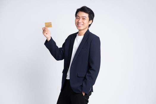 Young business man wearing a suit posing on a white background photo