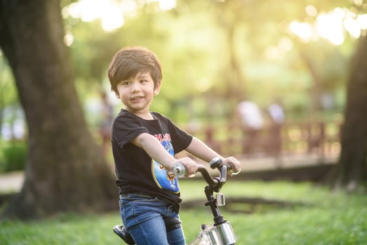 Bangkok Thailand - Oct 09, 2016  happy cheerful child boy riding a bike in Park in the nature photo