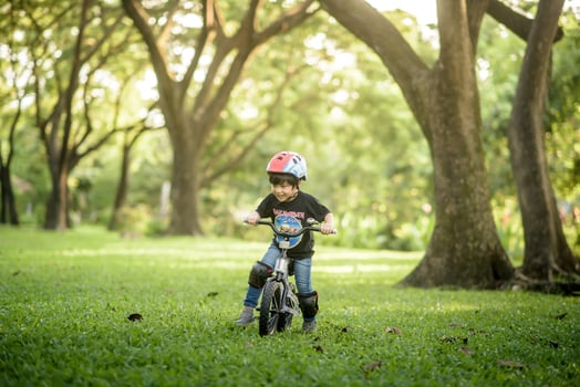 Bangkok Thailand - Oct 09, 2016  happy cheerful child boy riding a bike in Park in the nature photo