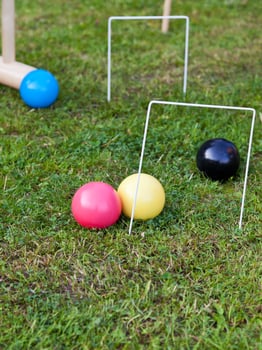 game of croquet on green lawn photo