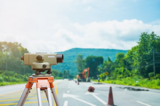 Surveyor equipment tacheometer or theodolite with road construction site background photo