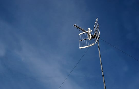 Antenna against a blue sky photo