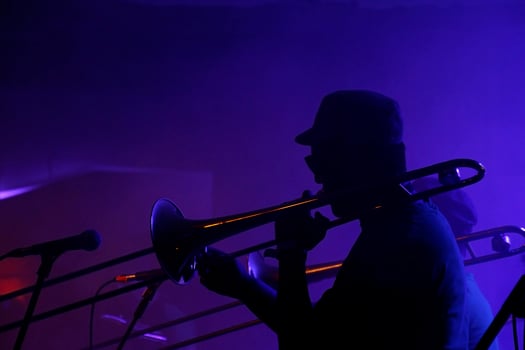 Silhouette of a Jazz musician in a dimly lit club photo