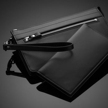 A closeup of a fashionable leather men's wallet on a dark background photo