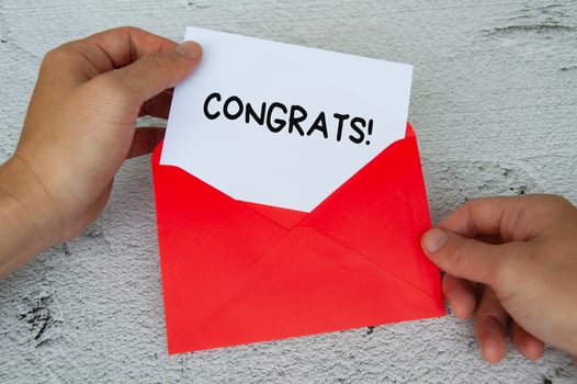 Congrats text on white notepad in red envelope. Appreciation concept photo