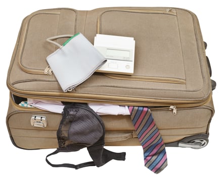 sphygmometer on suitcase with tie and bra photo