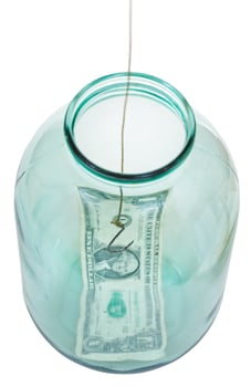 above view of last dollar and fishhook in glass jar photo