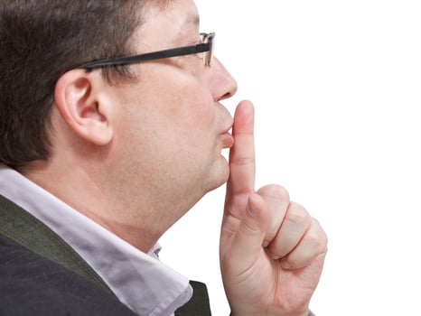 side view of businessman's finger near lips photo