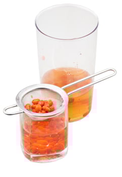 pot and glass with goji berries infusion isolated photo
