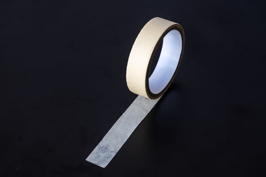 yellow paper tape isolated on black background photo