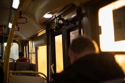 Inside bus is light of sun. People in transport. photo