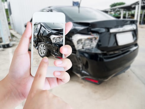 female hold mobile smartphone photographing car accident photo