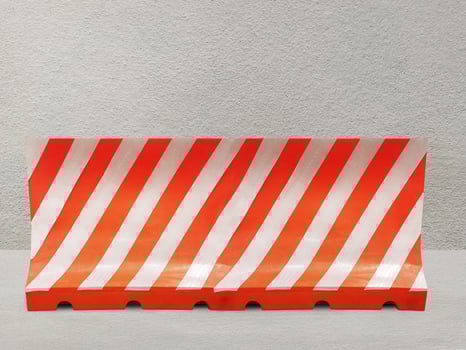 Red and white plastic blocks the walkway. on the cement background photo