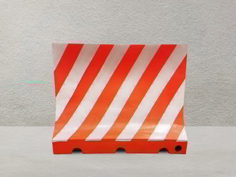 Red and white plastic blocks the walkway. on the cement background photo