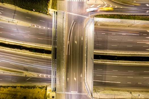 Beautiful night traffic junction road with lights of vehicle movement aerial view from drone. photo