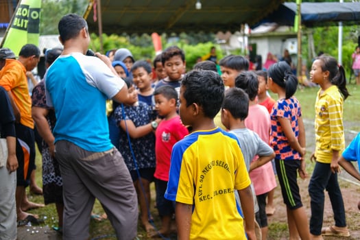 Blitar, Indonesia - September 11th 2022. A man from the competition committee who is distributing money to children to enliven the Indonesian Independence competition in Blitar photo