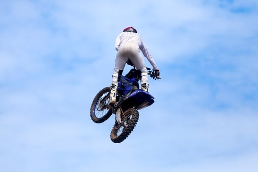 Biker doing a freestyle trick with his dirt bike photo