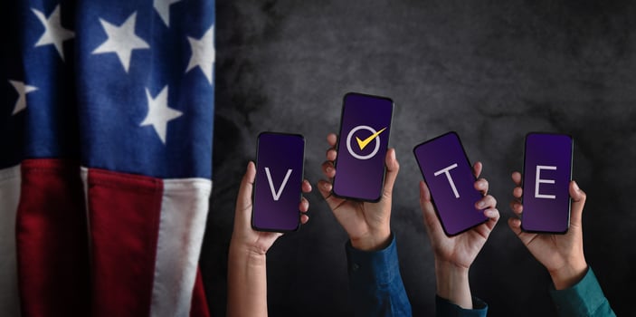 Voting Concept. Election in America. Group of People Raised Mobile Phone with Text Vote. Blurred Flag of United States as background photo