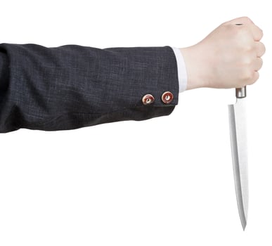 side view of knife in businessman hand photo