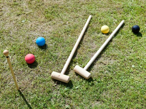 game of croquet on green lawn photo