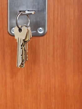 bunch of steel keys in keyhole of door photo