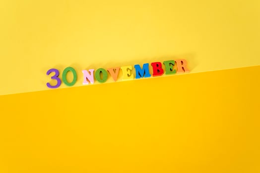 September 30 on a yellow and paper background with wooden and multicolored letters with space for text. photo