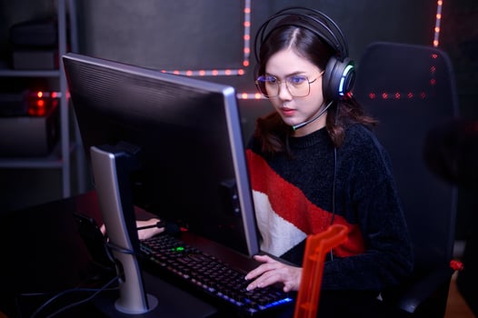 Young female professional Streamer and gamer with headset playing online video games photo