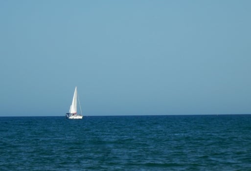 Sailboat on the blue horizon photo
