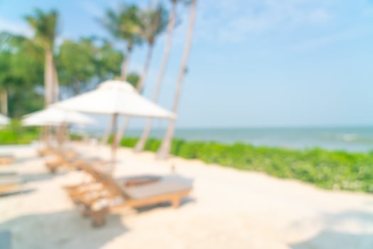 abstract blur umbrella with beach chair for background photo