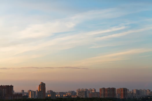 sunset sky over city in summer photo