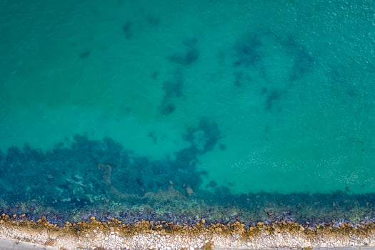 Top view aerial photo from flying drone of the beautiful transparent sea and coastline for your advertising text message or promotional content. website background.
