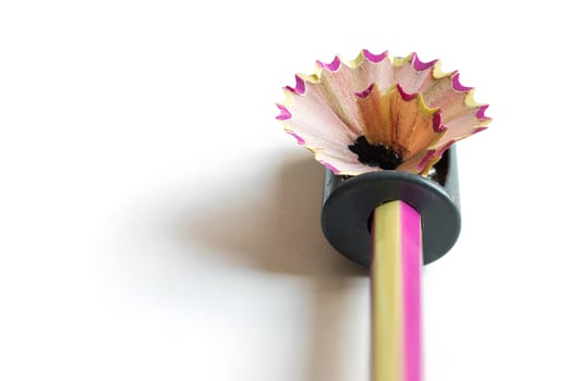 pencil with sharpening shavings on white background photo