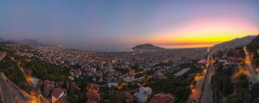 Alanya City, Antalya, 2022 Sea Bay panorama aerial bird view from above, beautiful sunset over resort city at mediterranean sea, drone point of view photo