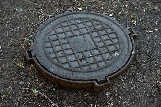 Iron manholes on the road in the city. photo