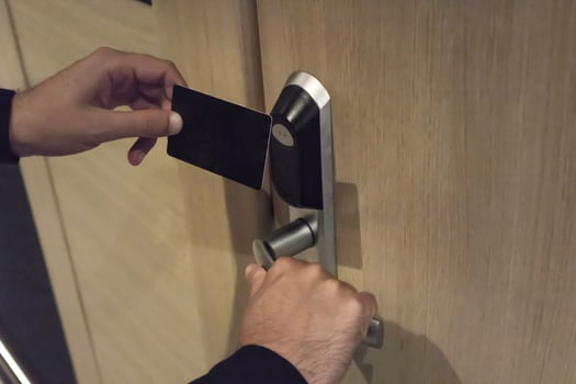 Close up of man using cardkey and unlocking hotel room. photo