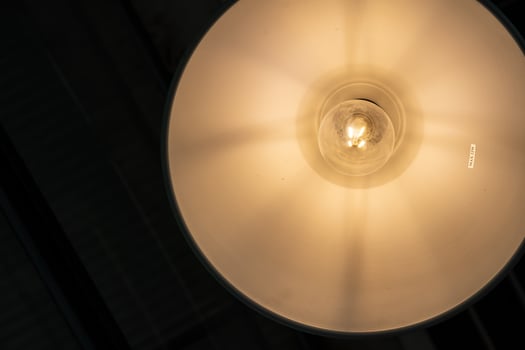 warm lights hanging from ceiling in local restaurant. Close-up shot with blurred background. Negative copy space photo