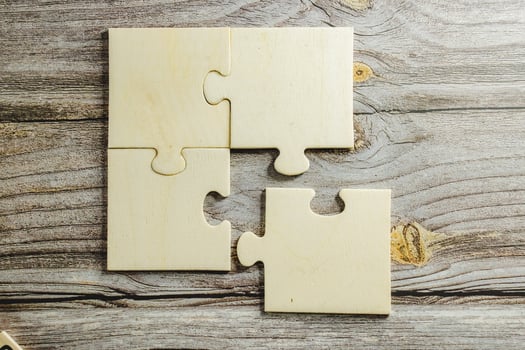 White jigsaw puzzle connecting together. Team business success partnership or teamwork concept. A group of business people assembling jigsaw puzzle. Business solutions, success and strategy concept. photo