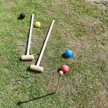 game of croquet on green lawn photo