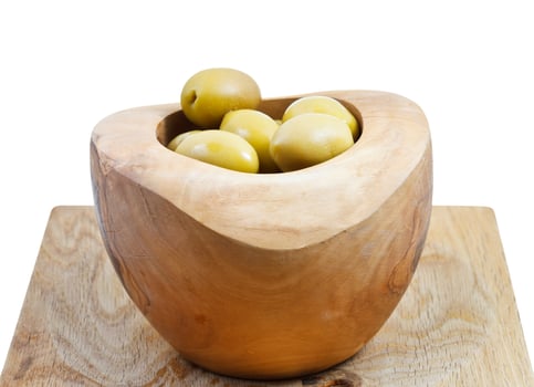 green olives in wooden bowl on board isolated photo