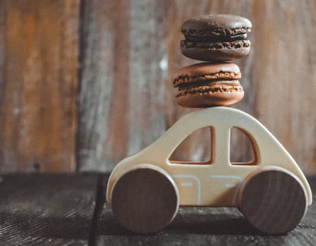 Sweet macaroons on Wooden Toy car photo