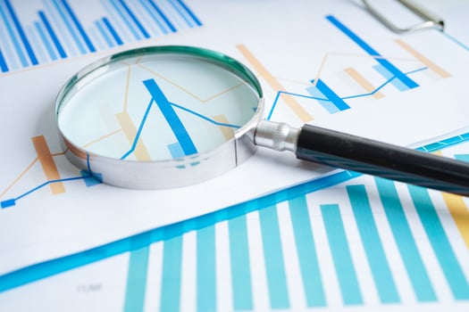Magnifying glass on charts graphs paper. Financial development, Banking Account, Statistics, Investment Analytic research data economy. photo