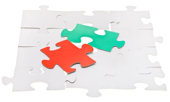red and green pieces on assembled white puzzles photo