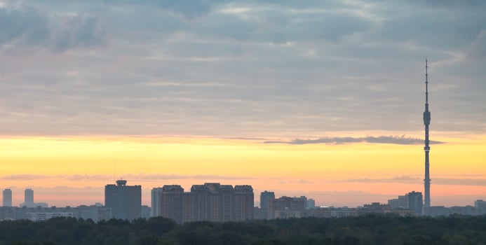 panorama of city under grey clouds at sunrise photo