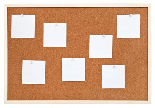 several sheets of paper on bulletin cork board photo