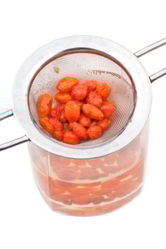 strainer and glass with goji berries tincture photo
