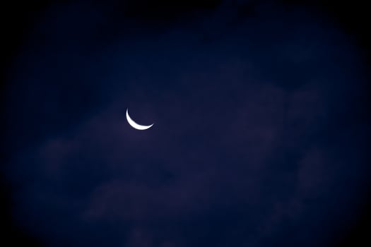 Half Moon in the early evening on dark blue sky, photo
